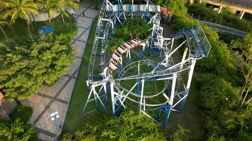 Beautiful Top View Pov Shot of Twisting Red and Blue Roller Coaster Roller Coaster in the Amusement