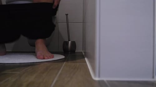 Man Approaches Toilet with Bare Feet