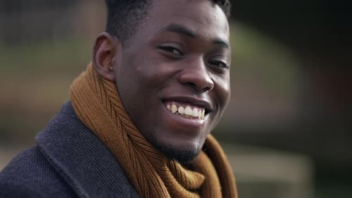 Close-up of Smiling Man with Scarf and Coat