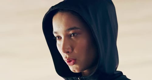 Young Adult Woman in Black Hood Talking