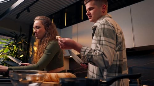 Couple Cooking Together, Feeding Each Other Bread
