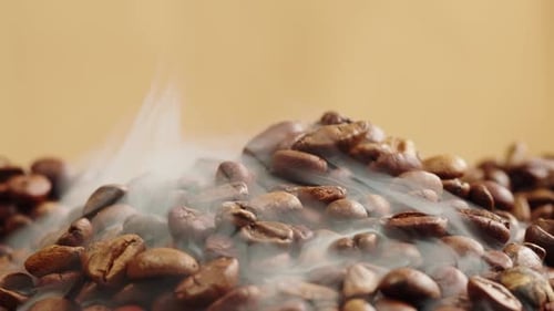 Roasting Coffee Beans with Smoke on Dark Background Close Up Arabica Robusta Colombian Beans