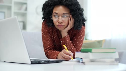 Young Adult Woman Studying at Home With Laptop