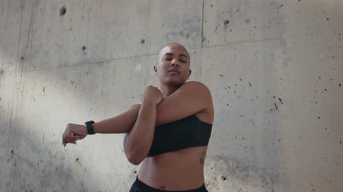 Woman Stretching Arms in Urban Outdoor Setting
