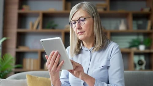 Woman Using Tablet Device at Home