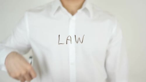 Writing the Word Law with Marker on Glass