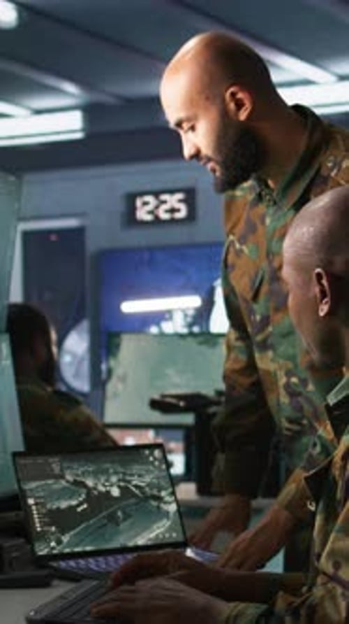 Vertical Video Experts Using Tracking Gear and Radar Systems in Command Center