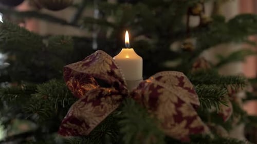 Lighting up a candle on a christmas tree with fire