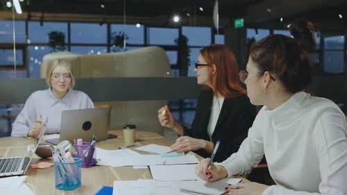 Women Collaborating on Project in Modern Office