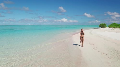 Young Woman Walking on Tropical Beach in the Maldives
