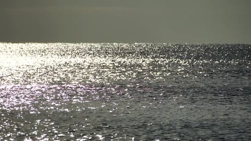 Abstract Shining Sun Reflections on Blue Surface of Sea Waves Bokeh Sun Glare Reflected in Water