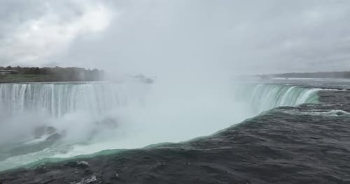 Water falling down a waterfall from Niagara Falls in Canada overlooking the American side.
