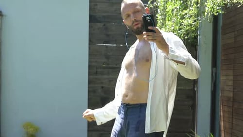 Young Man Listening to Music and Dancing in Garden 30s