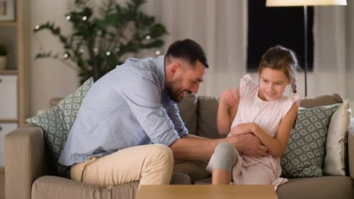 Man and Girl Having Fun Together on Couch