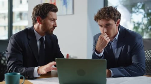 Business Partners Discussing Project at Laptop Sitting Corporate Office Closeup