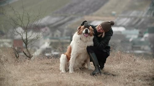 Woman and Dog Cuddling in Rural Setting