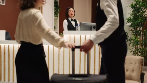 Couple Arriving at Upscale Hotel Reception