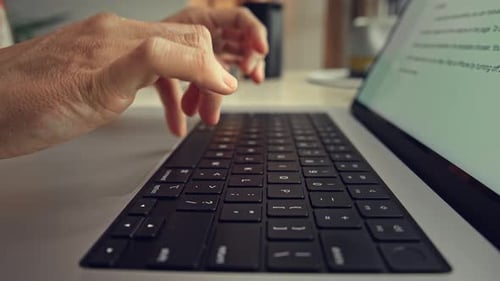 Hands of Woman Typing on Keyboard of Laptop Computer and Working in Home Office