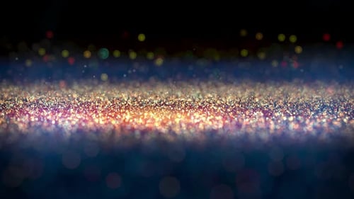 Dark background with golden particles flying up loop