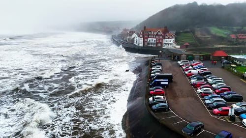 Stormy winter scene. Rough seas of the English coast with mist and fog. Aerial footage of the sleepy