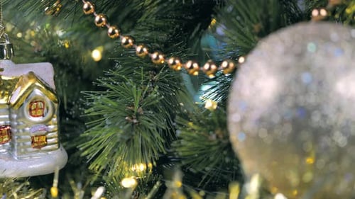 Decorated Christmas Tree with Gold Ornaments and Lights