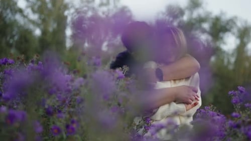 Romantic Embrace in a Purple Flower Field Young Couple in Love