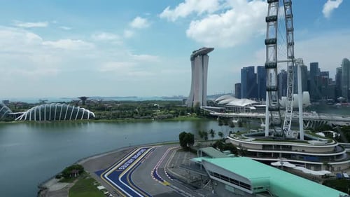 Drone shot orbiting turn 1 of Singapore Formula 1 track. Singapore Flyer, Marina Bay Sands Hotel, He
