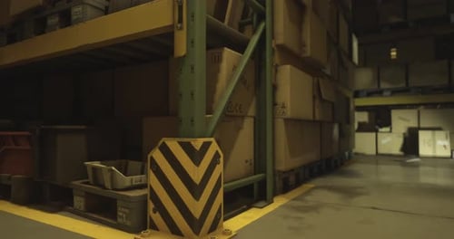 Warehouse Storage Area with Boxes and Pallets During Evening Hours