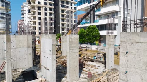 Aerial View Concrete Being Poured By Workers at a Busy Building Site