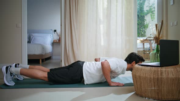 Man Performing Plank Position on Yoga Mat Browsing Laptop Video Male ...