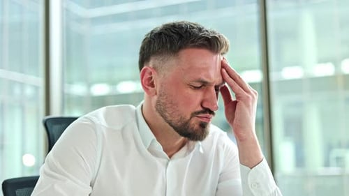 Businessman Suffering From Headache in Office Stress and Pressure at Work