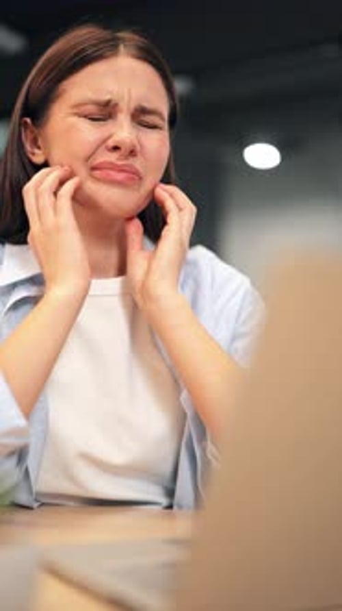 Woman Suffering From Severe Toothache in Office