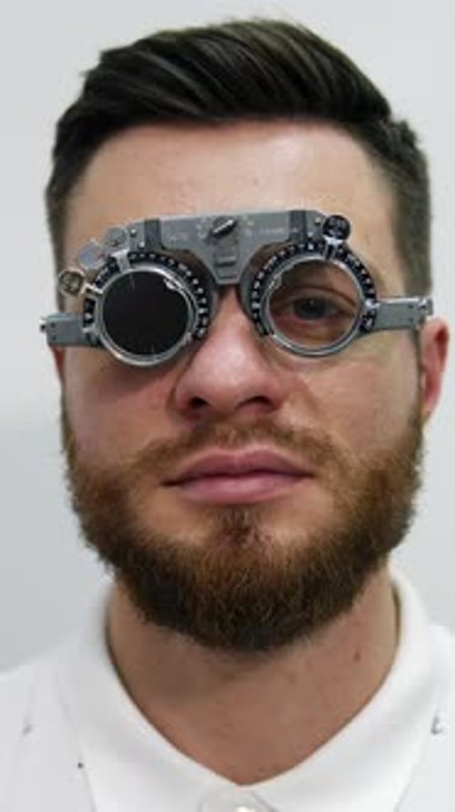 Man Wearing Eye Testing Device During an Eye Exam