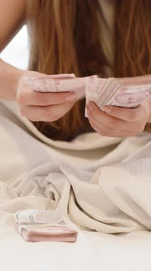 Woman Counting Money at Home