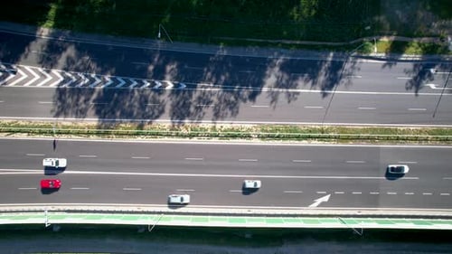 Overhead View Of Vehicles Driving Through The Asphalt Lanes Of Highway. - aerial
