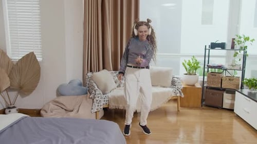 Woman Dances to Music in Bright Living Room
