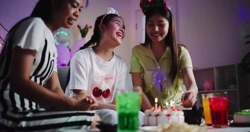 Friends Celebrating Birthday with Cake and Candles Indoors