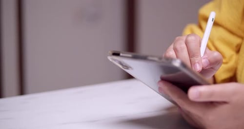 Tablet use with stylus in close up shot