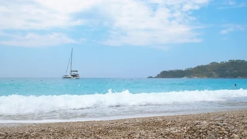 Speed boat drifting by shore.