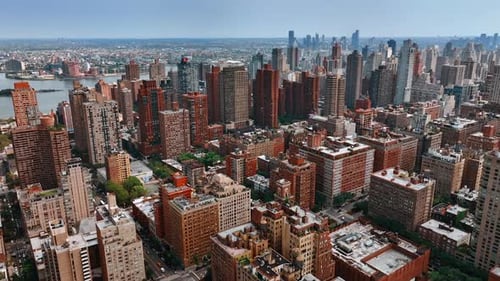 Immense urban landscape from top at daytime. Drone flight above the building with orange facades.