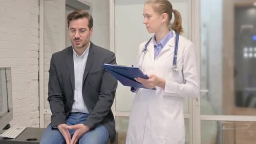 Patient Talking with Female Doctor in Clinic