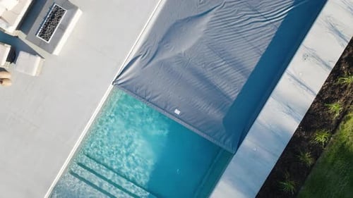 Modern Backyard with Inground Fiberglass Pool and Pool Cover in Motion