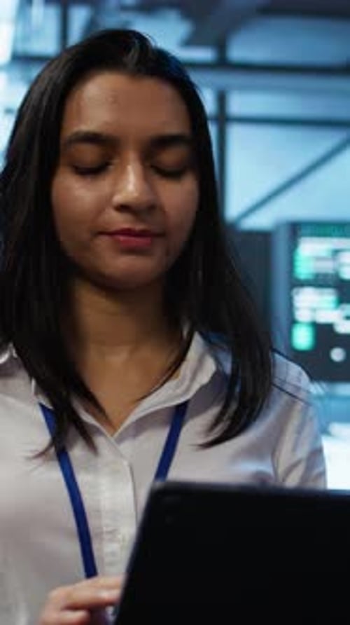 Focused Young Adult Woman Using Tablet Indoors