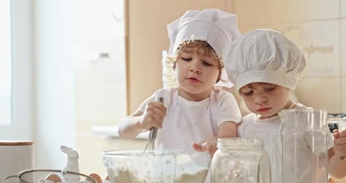 Little Chefs in Training Boys Mixing Batter Together in Slow Motion