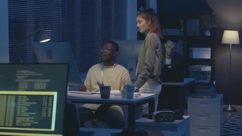 Team of Software Engineers Co-working at Night