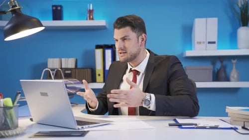 Frustrated young businessman scolding his employees at video conference meeting.
