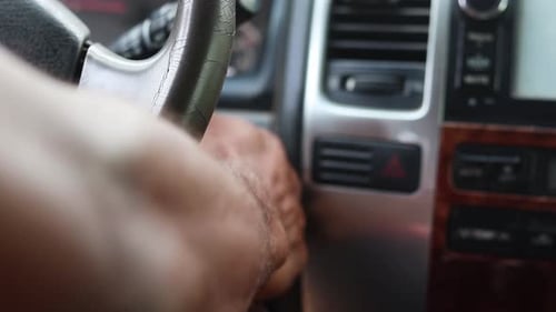 Male hand starting his car with a key