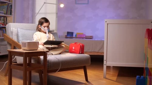 Child Using Nebulizer with Tablet Device at Home
