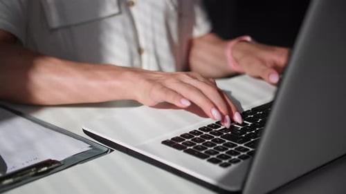 Work in Office a Woman's Hand is Typing on Laptop Keyboard Closeup