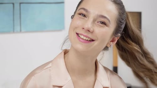 Smiling Woman with Ponytail and Satin Shirt